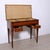 Wall-mounted writing desk in veneered wood and inlaid with floral motifs, with a lift-up top and internal compartments...
