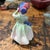 This sweet little figure is in a green and blue color way and was designed by leading Royal Doulton artist Leslie...