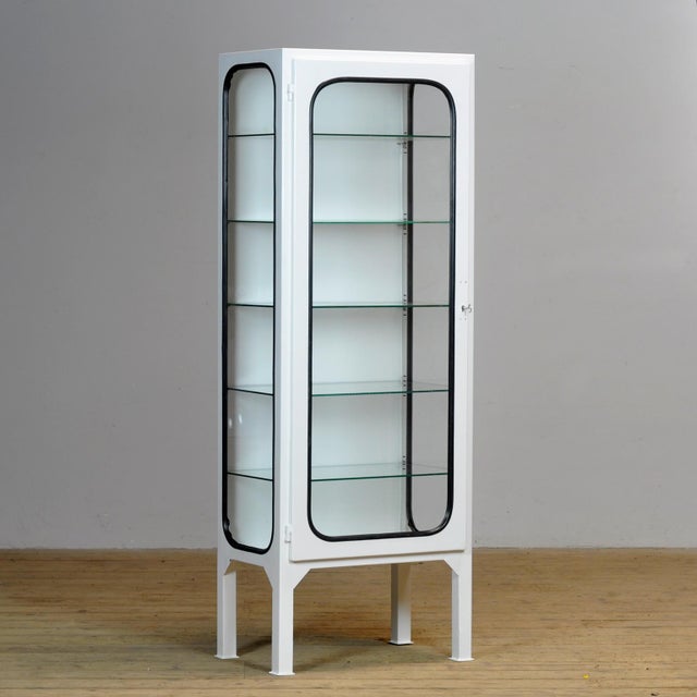 Vintage medical cabinet from the 1970s, made in Hungary. This characterful cabinet is made of iron and glass, with the...