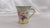 This is a pair of R&S Germany chocolate cups in a tulip shap with a floral design. The porcelain is slightly fluted with...
