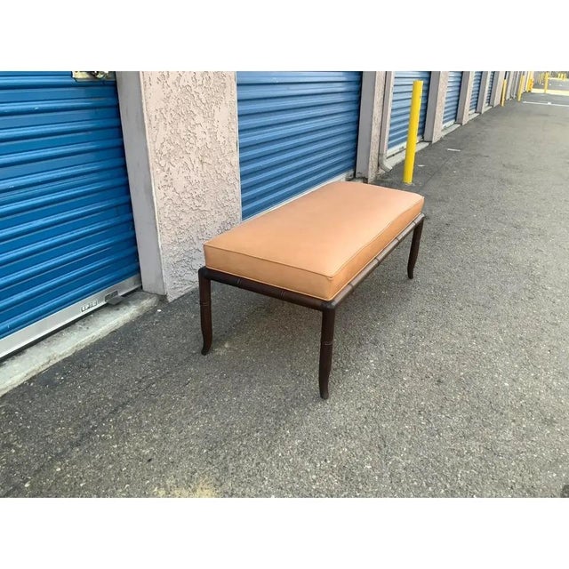Mid century modern walnut bench with leather upholstery. The bench is done is the manner of Robsjohn Gibbings . This style...