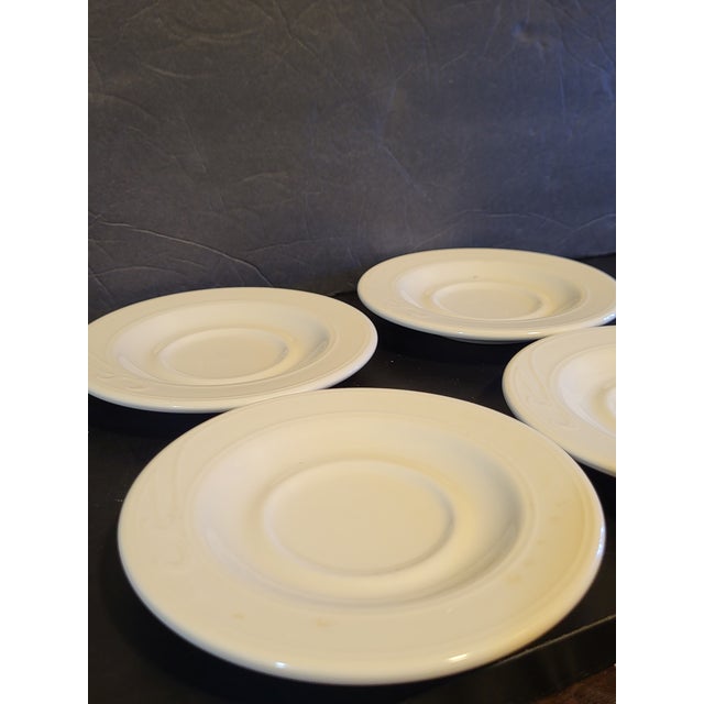 20th Century Homer and Laughlin white ironstone saucers. Set of 4.It has a desirable timeworn discoloration to glaze....