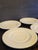 20th Century Homer and Laughlin white ironstone saucers. Set of 4.It has a desirable timeworn discoloration to glaze....