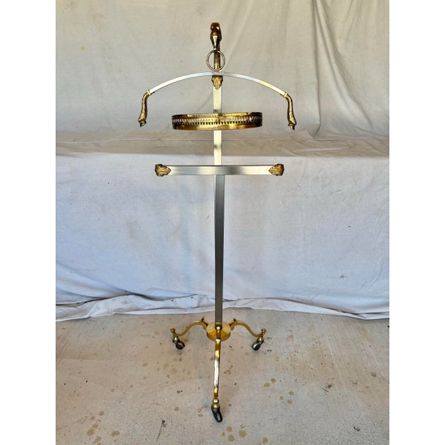 This Mid 20th Century Italian Maison Jansen Style Mixed Metal Gentleman's Valet Stand dates back to the 1960's. The piece...