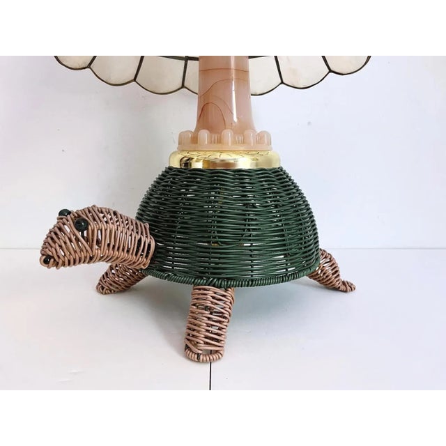 Darling whimsical wicker turtle lamp from the 1960s with blush pink head and legs, green scalloped shell, pink glass neck,...