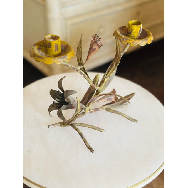 A charming vintage toleware candleholder designed as a cluster of hand-crafted flowers and foliage. Featuring two candle...