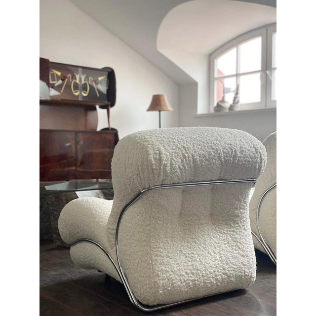 Very stylish armchairs with steel frame and curvy shapes. Reupholstered in off white boucle fabric. There is an option to...