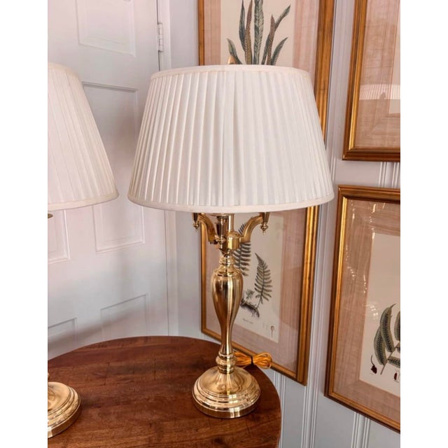 Beautiful pair of very heavy brass lamps with a classic three-arm, bouillotte style. Bases are in exceptional condition...