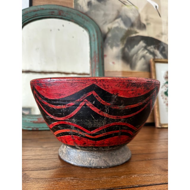Stunning antique turned and carved wood opium or prayer bowl. Vibrant red paint decoration on a black field. This piece...