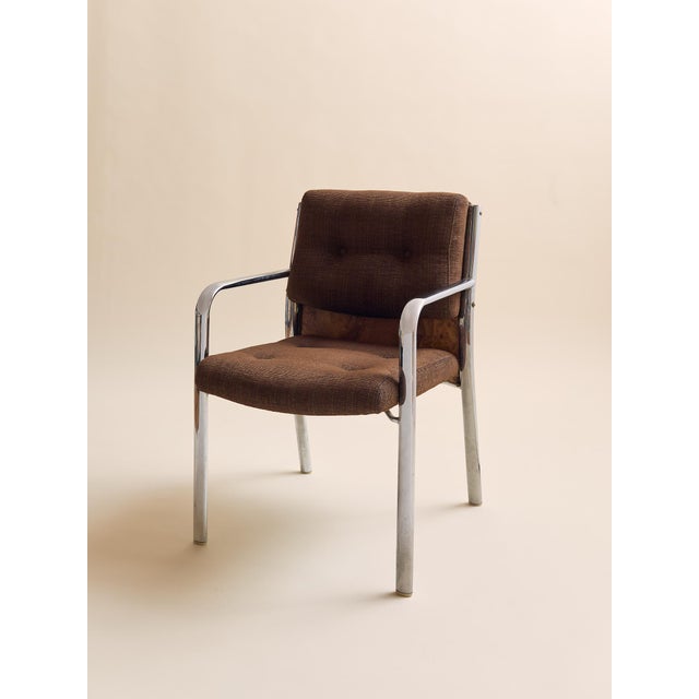 This pair of armchairs combines tubular chrome frames with upholstered wool brown seats and backs, accented by striking...
