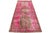 This vintage Persian wool rug features a pink field with gray tribal accents. This rug measures 3' 9" x 9' 8".