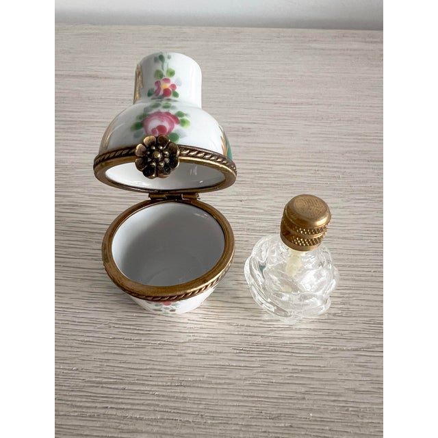 A charming and highly collectible hand-painted Limoges porcelain trinket box, beautifully designed in the form of a petite...