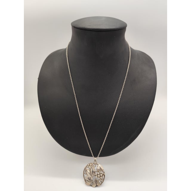 Art Deco necklace with amulet, floral hearts and grapes, 800 silver, from the 1920s. Besides the 800 mark, there is...