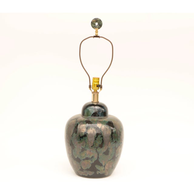 This black and green ceramic lamp base has a traditional ginger jar shape and is topped with a handmade kambaba jasper...