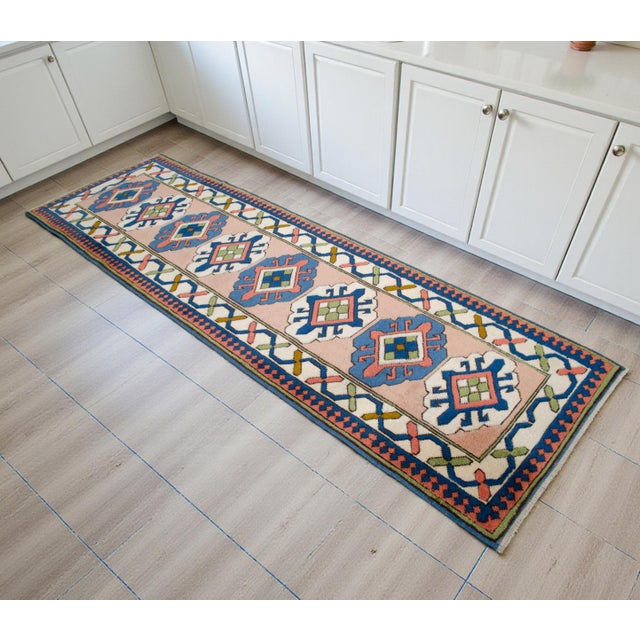 This authentic 1990s Eastern Anatolian runner rug serves as a striking foundation for sophisticated interiors,...