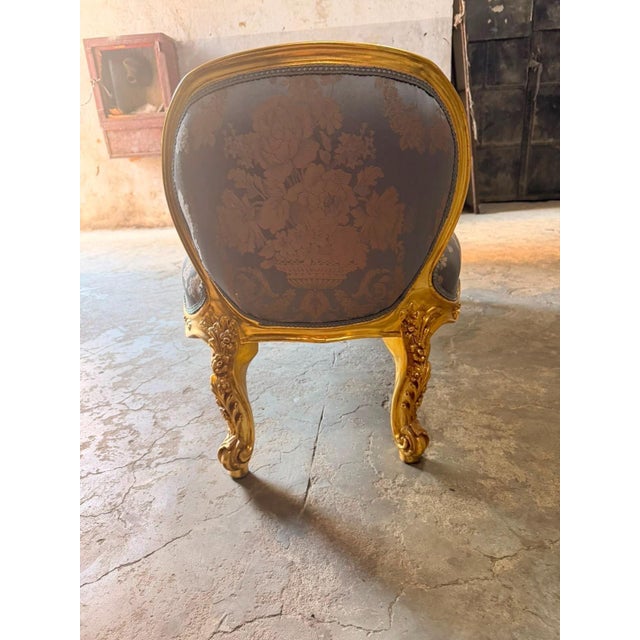 An elegant French Louis XVstyle double-ended bench / window seat, featuring a richly carved gilt frame and soft blue...