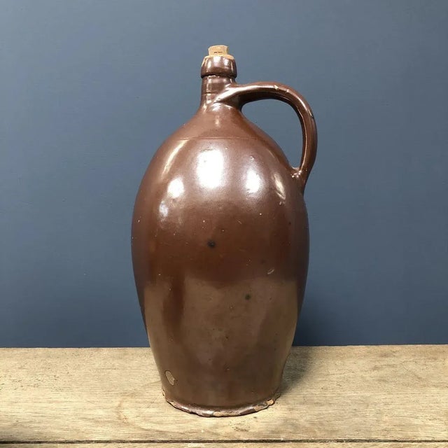 Nice big brown glazed earthenware jar with cork stopper from the 19th century. A wonderful decorative piece for your...