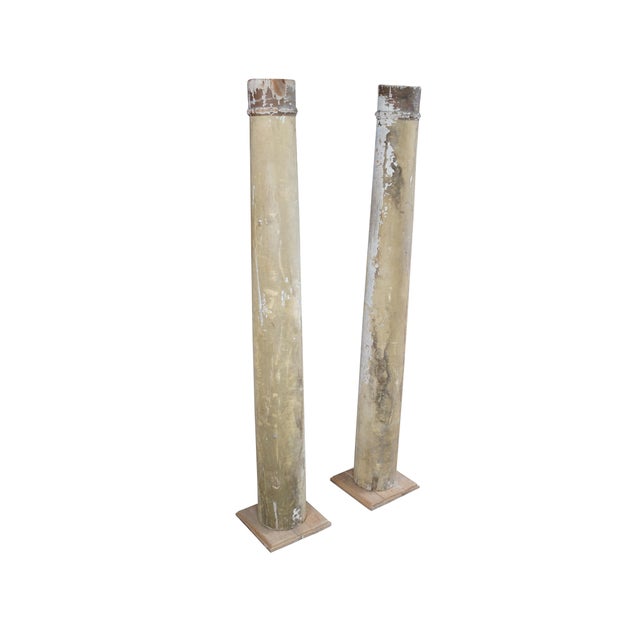 Pair of decorative reclaimed columns on plinth bases. Made from hardwood with a naturally aged painted patina showing...