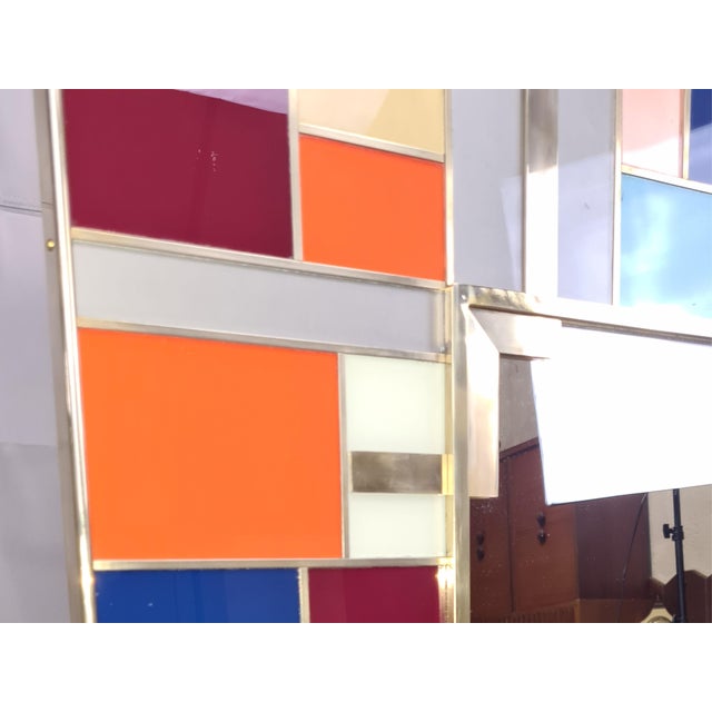 Multicolor Murano glass wall mirror, a masterpiece of modern style and Italian artistic tradition. Handcrafted in Italy,...