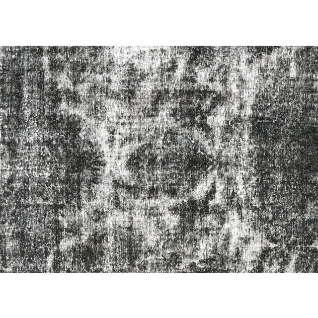 This Vintage Persian Kerman Overdyed Rug, measuring 9'7" x 14'1", is handwoven with wool on a cotton foundation in Iran...