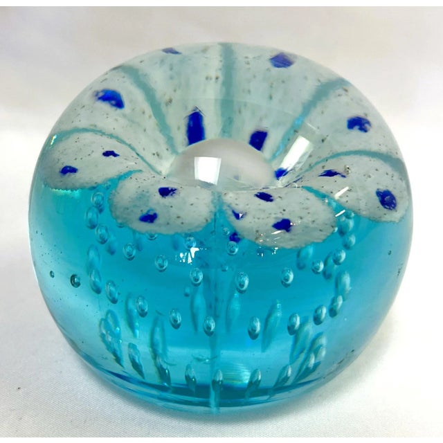 Beautiful mid century art glass paper weight in the Murano glass style. The blown glass has a twisting blue and white...