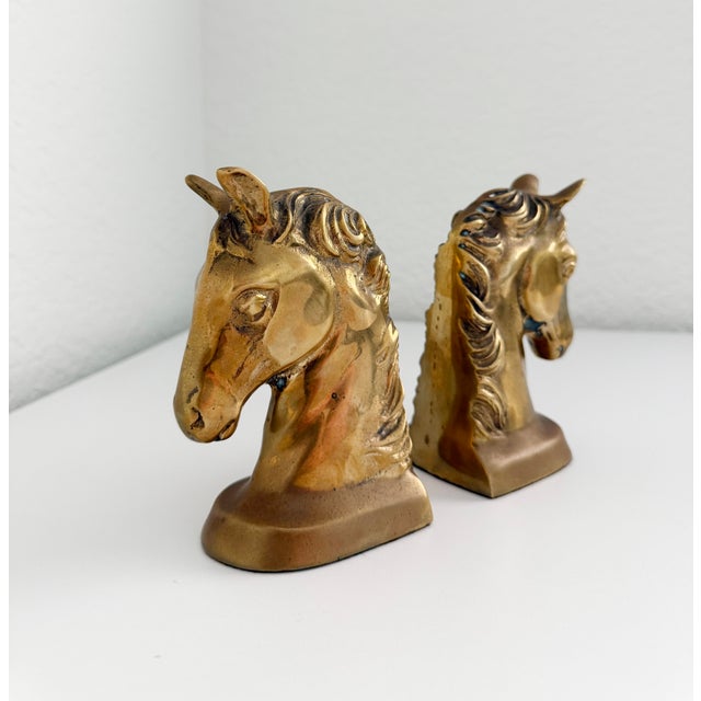 A wonderful pair of mid-century aged brass horse head bookends. The manes include some verdigris coloration to the brass...