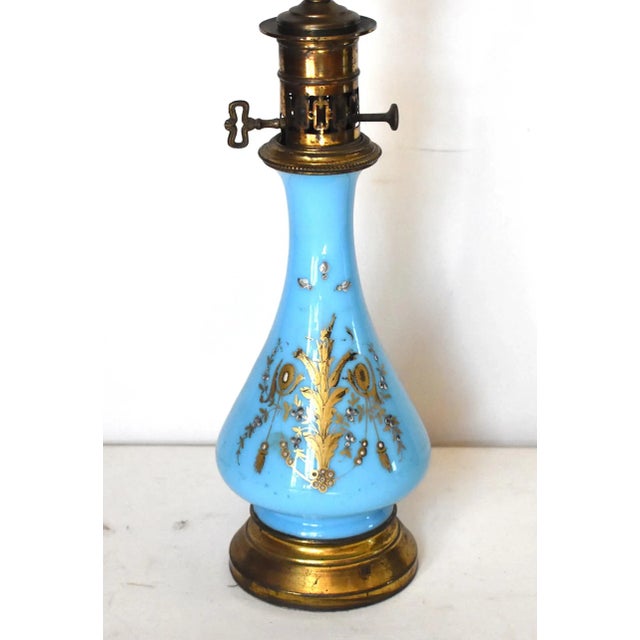 An antique, 19th-century French turquoise, robin's egg, or "Sevres" blue opaline glass table lamp with swag and foliate...
