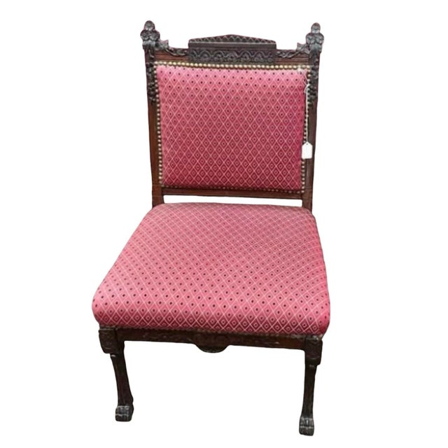 Beautiful pair of late-19th-century Victorian Renaissance Revival side chairs with deep, heavily carved solid wood frames....