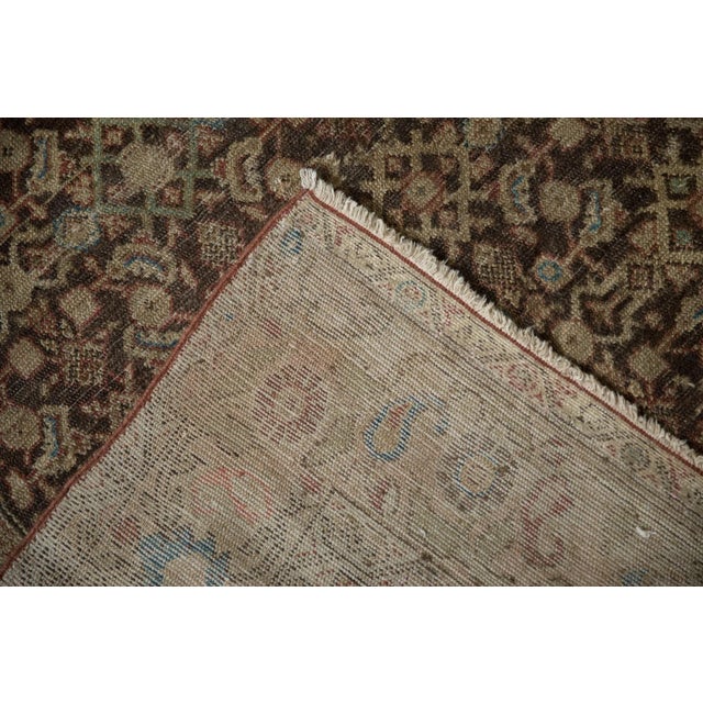 :: Covered field in a Herati design motif wrapped by a boteh and palmette main border and inner outer minor borders in a...