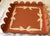 Charming vintage metal tray with a scalloped edge and a hand painted cream bow border. The tray is terracotta pink color...