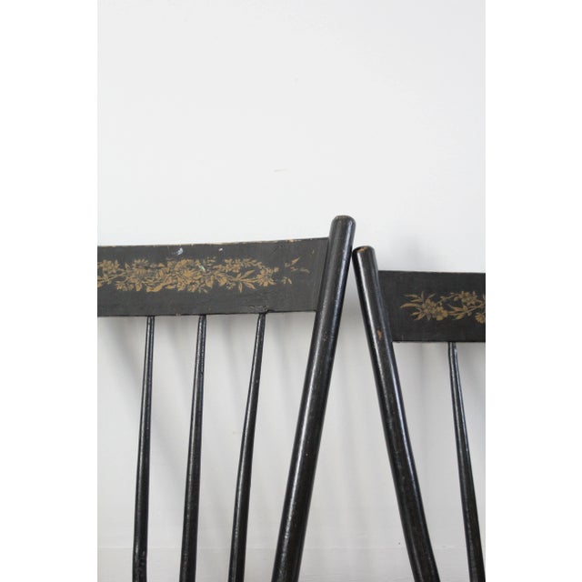 This is an exceptional set of four antique Windsor chairs with stencil backs. The ebony painted dining chairs feature...