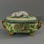 Minton Majolica game pie dish with liner which features a hunting dog asleep next to a gun, a powder flask and a game bag....