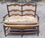 A very beautiful in excellent condition is this country French Rush seat carved two seat bench with a French Market...