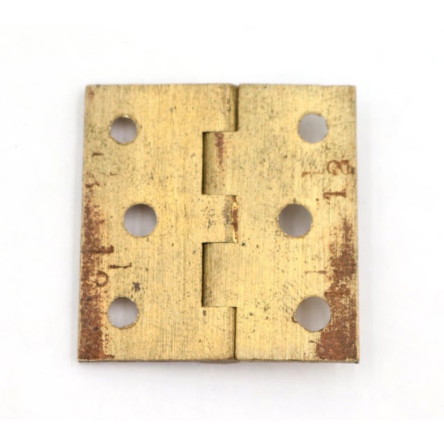 Vintage cabinet hinge made of brushed brass with flat tips, five knuckles, and a template hole pattern. The original...