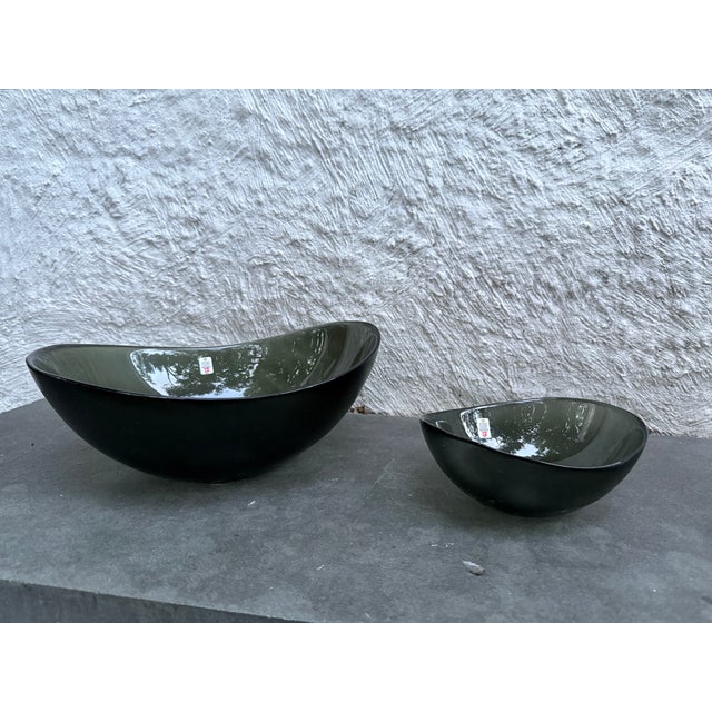 Set of amorphic shape ghray lass bowls with textured exteriors. Design by Per Lutken, for Holmegaard, Denmark. The pattern...