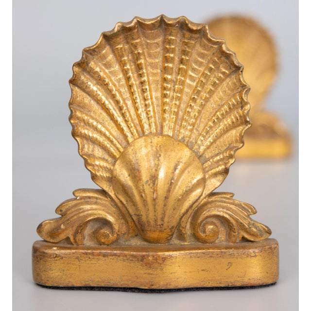 A gorgeous pair of early 20th-Century gilt plaster seashell book ends made by Borghese in Italy, circa 1930. Maker's label...
