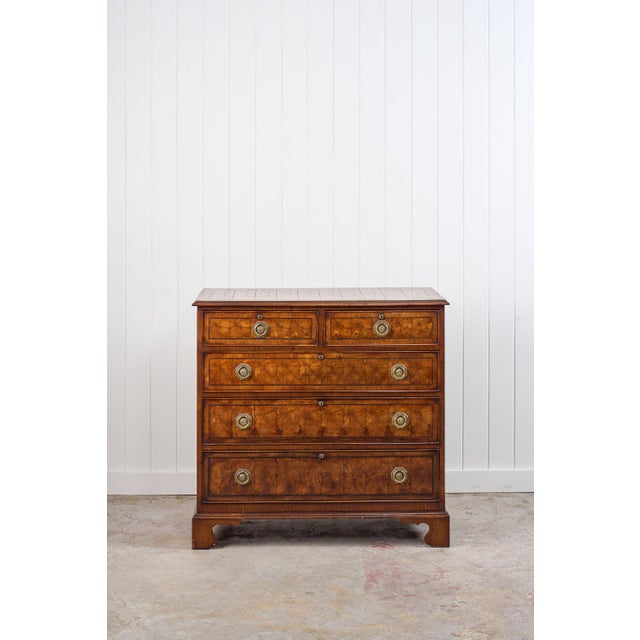 This 18th-century English oyster-cut chest of drawers features bookmatched oyster-cut walnut on the top and the drawers....