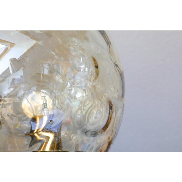 Mid-Century Glass & Brass Pendant Light, 1970s, in Very Good conditions. Designed 1970 to 1979 This piece has an...