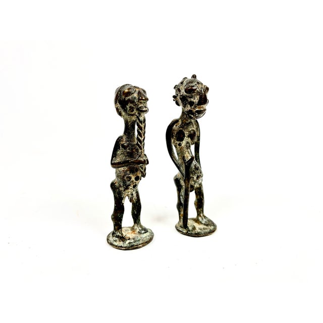 A charming pair of figures representing a couple in Baule society. The Baule stylistic canon is clearly defined on these...