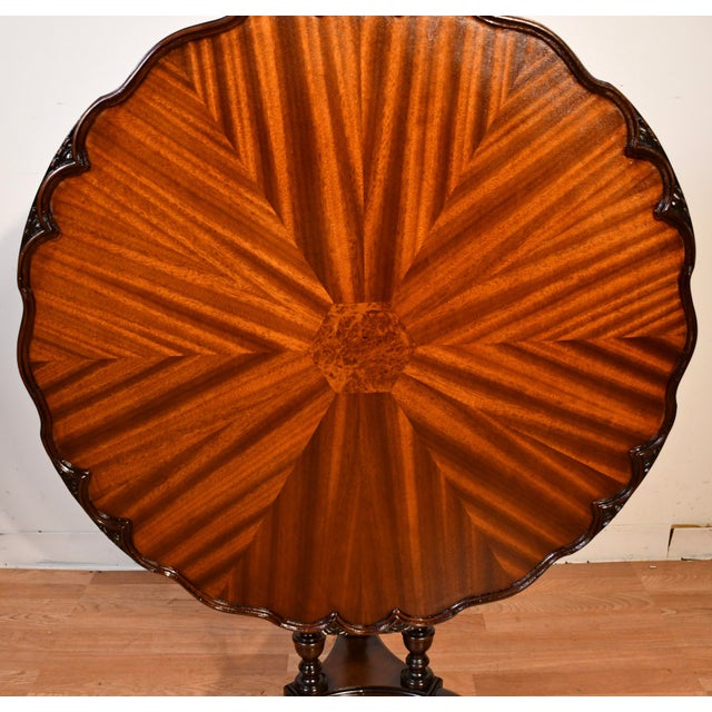 We are pleased to offer this beautiful English Tilt-top Pie Crust table, from the 1930s. This table is made of Flame...