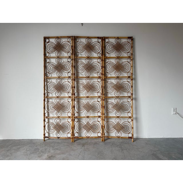 Beautiful 1970’s vintage coastal-style three-panel folding screen crafted from natural bamboo and hand-woven rattan. This...
