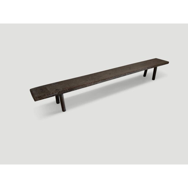 Beautiful bench hand made from a century old two inch thick panel with beautiful patina. We added smooth teak cylinder...