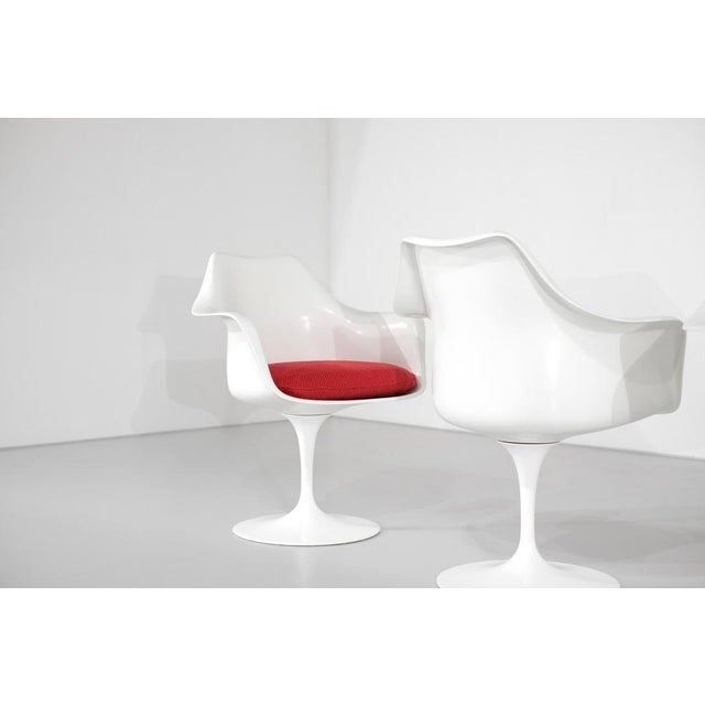 Set of four "Tulip" armchairs. White lacquered aluminum base. Fiberglass frame with red wool fabric cushions. Designed by...