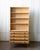 A tall Danish oak bookcase produced in the 1970s in the manner of Henning Kjærnulf, combining the clean proportions and...