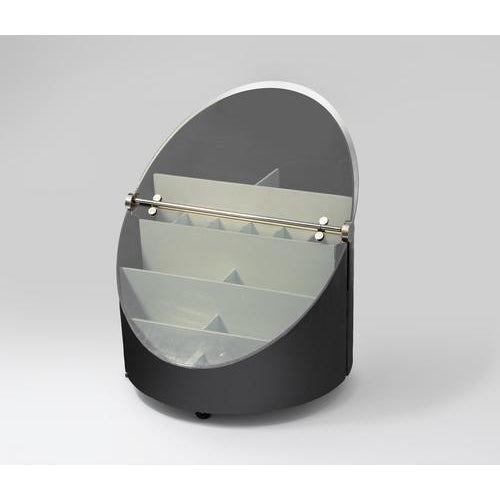 Black lacquered wood, smoked curved glass, chromed steel fittings, internal compartments in lacquered wood. The napoleone...