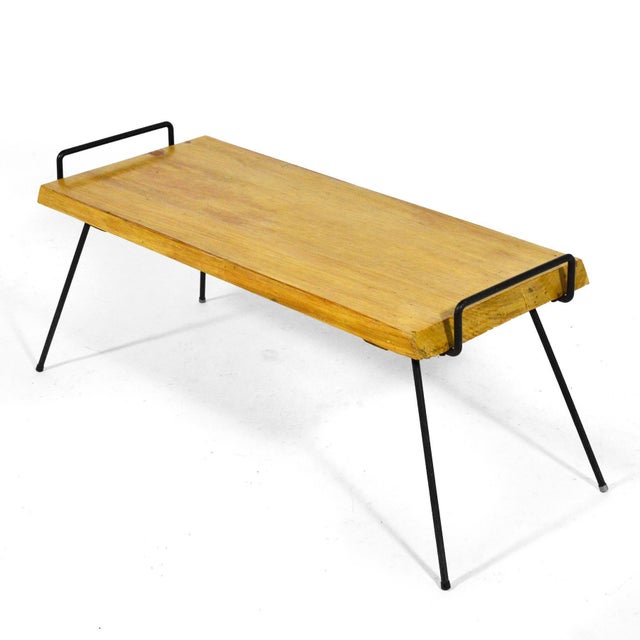 This striking piece has a top of solid wood supported by hansome black iron legs which wrap around from the underside to...