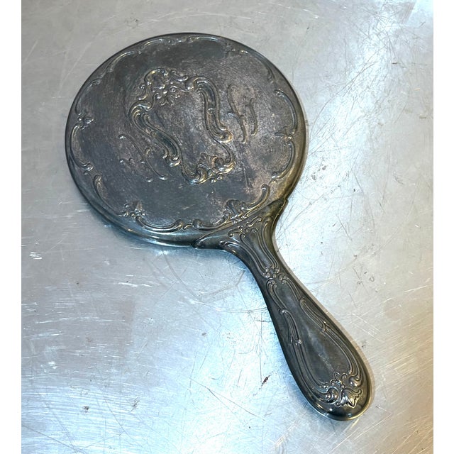 1930s-40s silver hand/vanity mirror. Some minor patina to metal throughout but otherwise excellent condition. Measures 10"...