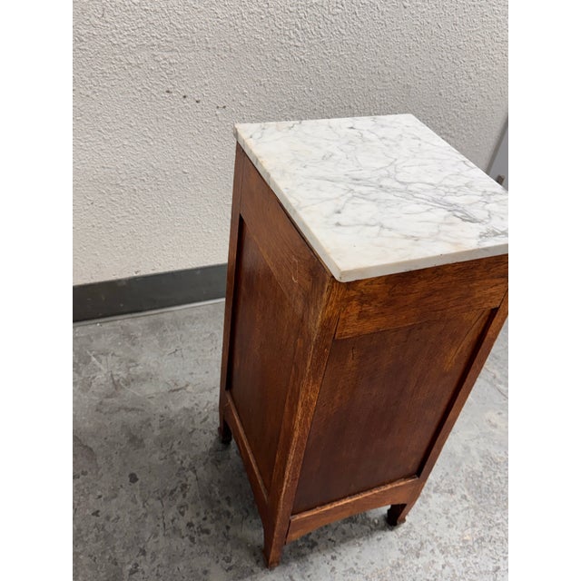 Design Plus Gallery presents a Antique French Art Deco Oak Side Table. This antique oak side table showcases Art Deco...