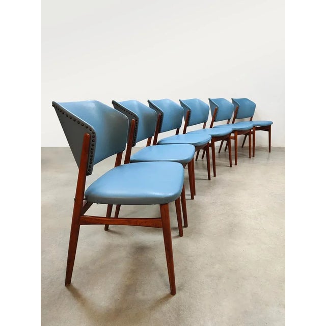 This unique set of six vintage dining chairs from the 1960s adds a touch of color to your interior. The warm wooden frame...