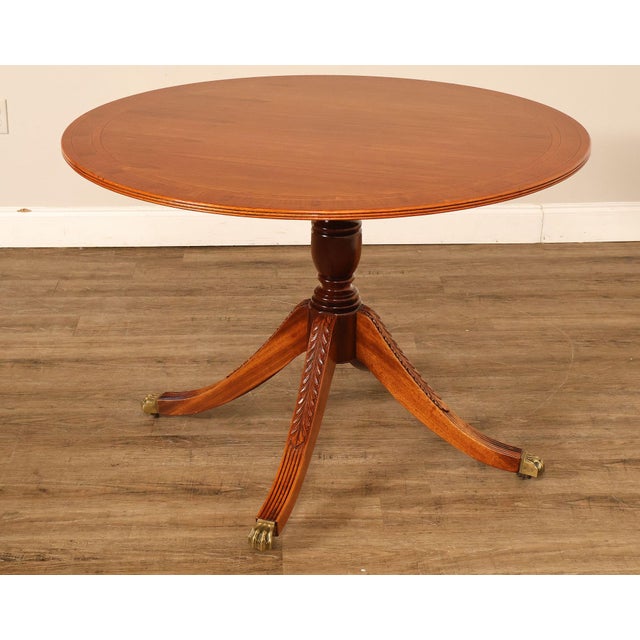 High Quality American Made Mahogany Round Breakfast Table In The Duncan Phyfe Style Featuring A Banded Top Above A Turned...